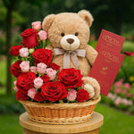 Load image into Gallery viewer, Teddy bear with a bouquet of red and pink roses on a wooden stand with a garden background.
