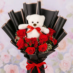 Load image into Gallery viewer, Bouquet of red roses with a white teddy bear holding a red bow, against a floral background.
