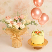Bouquet of flowers and a cake with balloons on a light background
