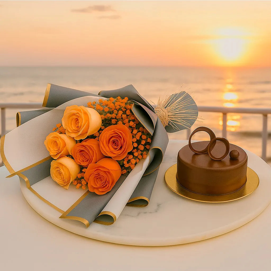 Bouquet of orange roses and a chocolate cake on a table with a sunset over water background