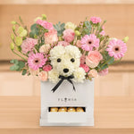 Load image into Gallery viewer, Floral arrangement with a white dog-shaped toy and pink flowers in a box, set against a wooden background.
