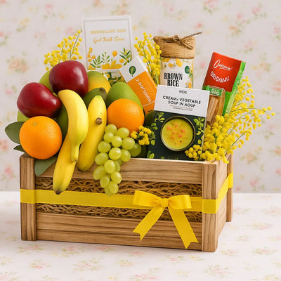 Fruit basket with a variety of fruits and snacks on a floral background