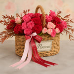 Load image into Gallery viewer, Wicker basket filled with red and pink roses on a light background
