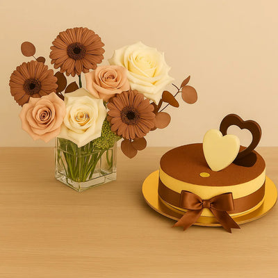 Bouquet of flowers in a vase next to a cake with heart decorations on a wooden surface.