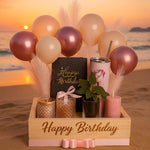 Load image into Gallery viewer, Birthday arrangement with balloons, candles, and plants on a beach at sunset.
